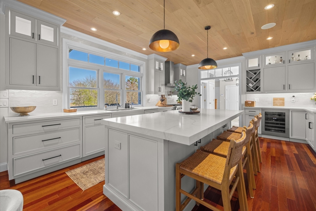 735 Bay Road Duxbury, MA 02332 - Photo 11 of 40 a kitchen with stainless steel appliances granite countertop a sink a stove and a wooden floors