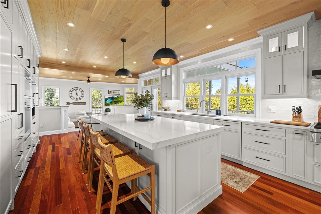 735 Bay Road Duxbury, MA 02332 - Photo 12 of 40 a kitchen with stainless steel appliances granite countertop a sink and a wooden floors
