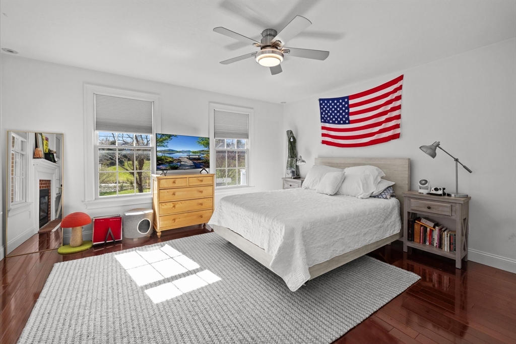 735 Bay Road Duxbury, MA 02332 - Photo 18 of 40 a bedroom with a bed and wooden floor