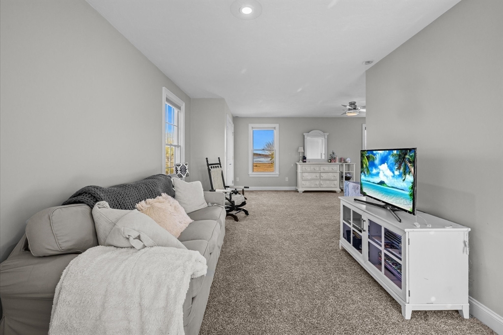 735 Bay Road Duxbury, MA 02332 - Photo 24 of 40 a living room with furniture and a flat screen tv