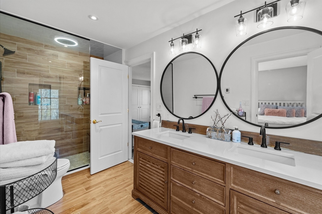 735 Bay Road Duxbury, MA 02332 - Photo 25 of 40 a bathroom with a double vanity sink a mirror and shower