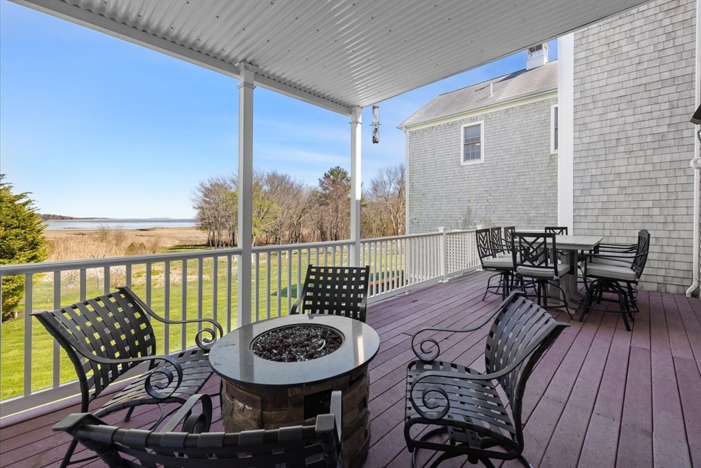 735 Bay Road Duxbury, MA 02332 - Photo 9 of 40 a view of a chairs and table on the deck
