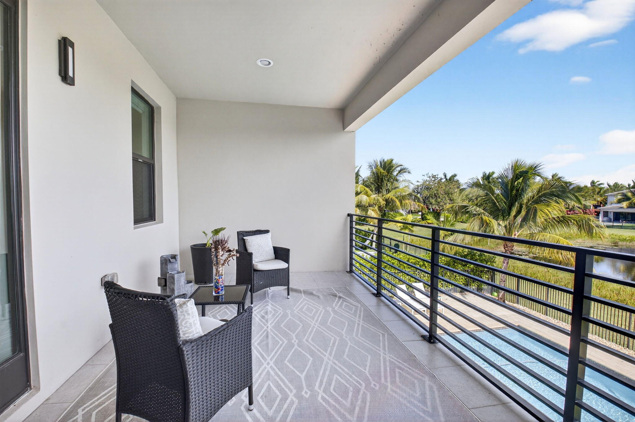 8573 Apple Falls Lane Boca Raton, FL 33496 - Photo 57 of 102 a balcony with table and chairs