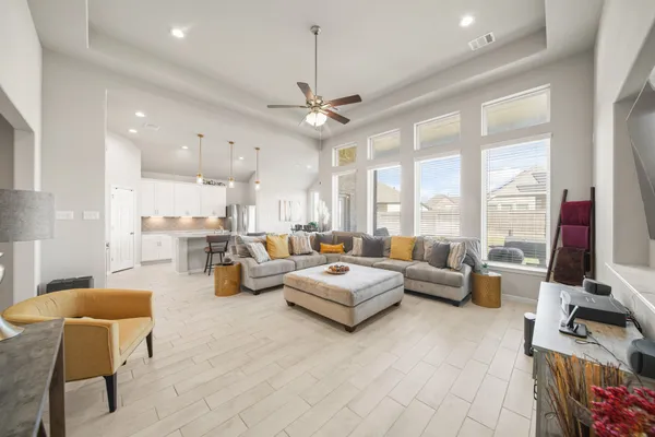 a living room with fireplace furniture and a large window