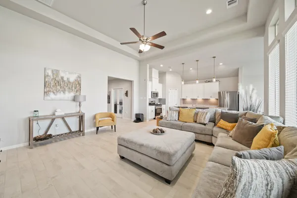a living room with furniture and a chandelier