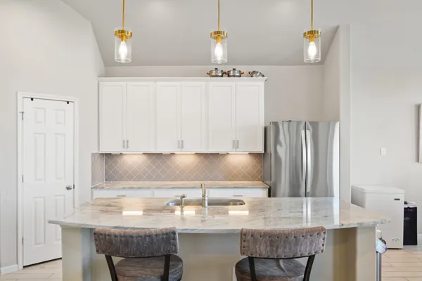 a kitchen with a sink cabinets and wooden floor