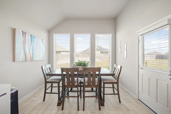 a view of a dining room with furniture and windows
