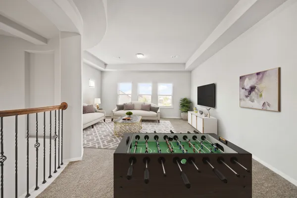 a living room with furniture a flat screen tv and a large window