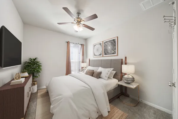 a bedroom with a large bed and a chandelier