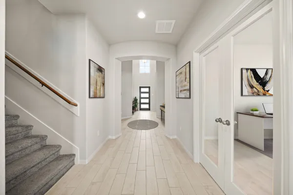 a view of a hallway view with wooden floor and staircase