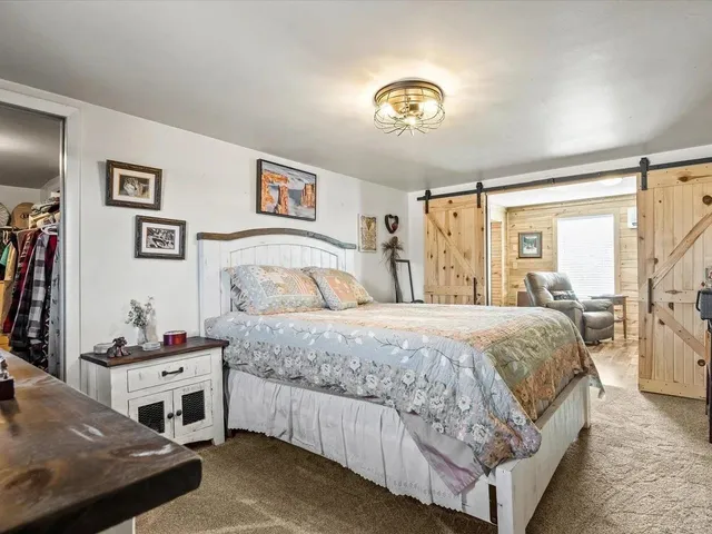 a bedroom with a bed and a chandelier