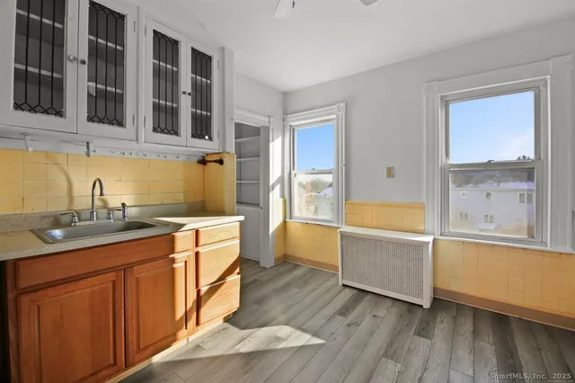 a kitchen with stainless steel appliances granite countertop a sink and wooden cabinets