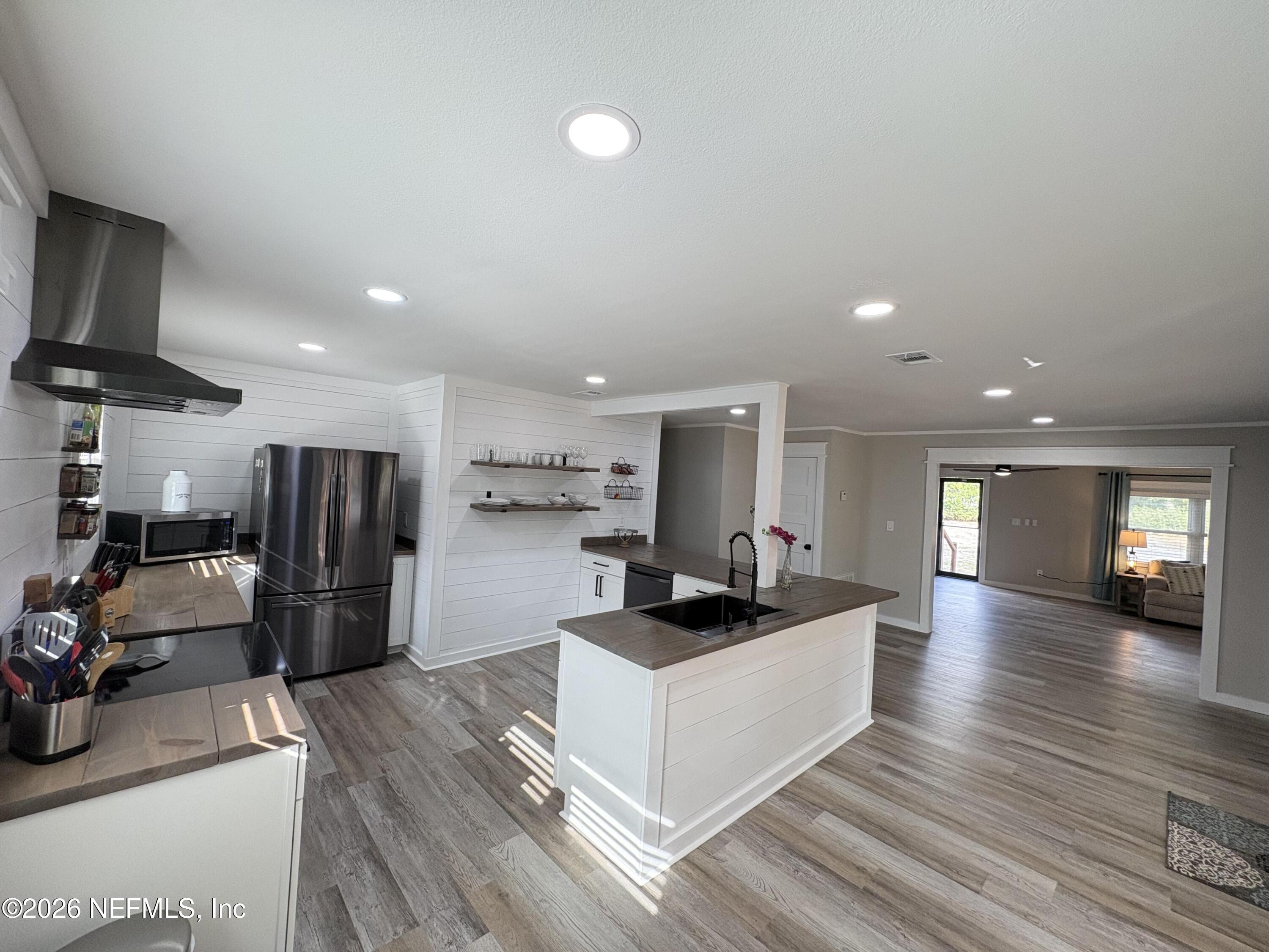 165 Fulton Road Palatka, FL 32177 - Photo 12 of 26 a kitchen with stainless steel appliances kitchen island granite countertop a refrigerator and a sink
