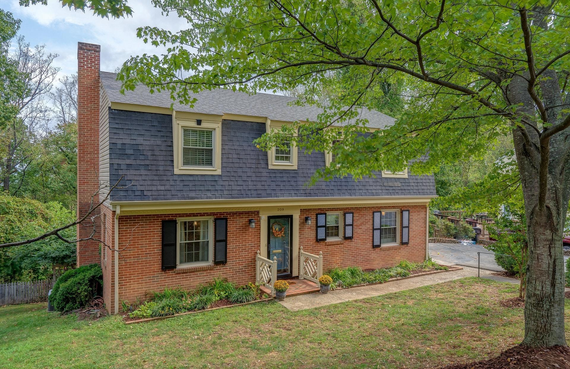 209 Parkcrest Road Southwest Roanoke, VA 24014 - Photo 1 of 48 a front view of a house with a yard
