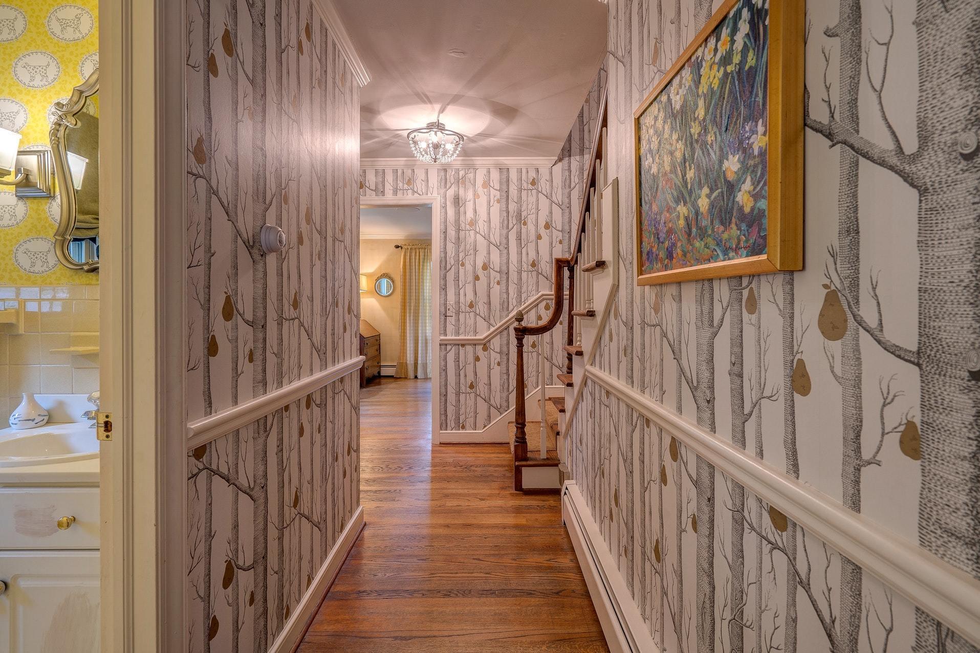 209 Parkcrest Road Southwest Roanoke, VA 24014 - Photo 24 of 48 a view of staircase with lots of frames on wall and wooden floor