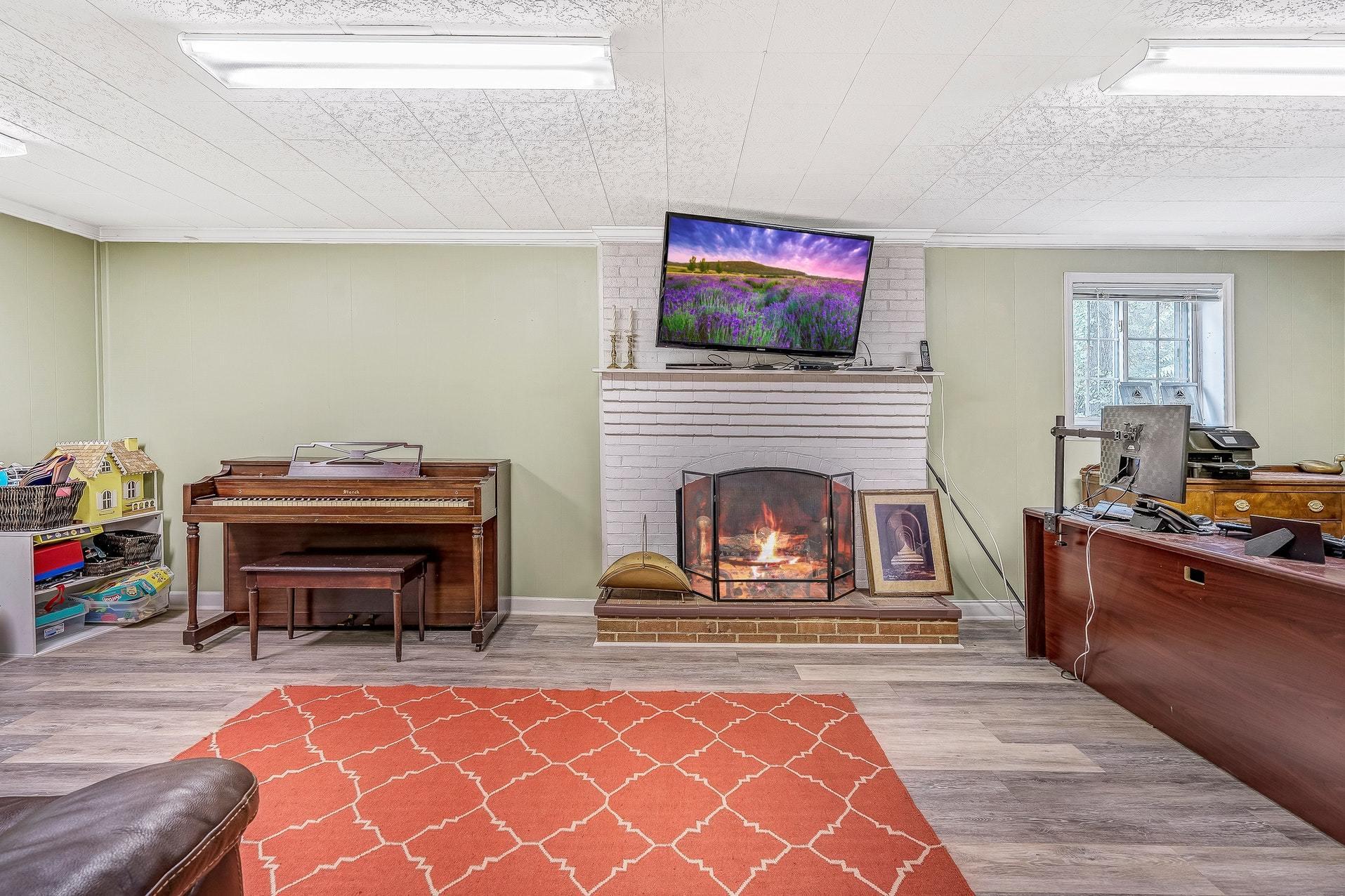 209 Parkcrest Road Southwest Roanoke, VA 24014 - Photo 42 of 48 a living room with furniture a flat screen tv and a fireplace