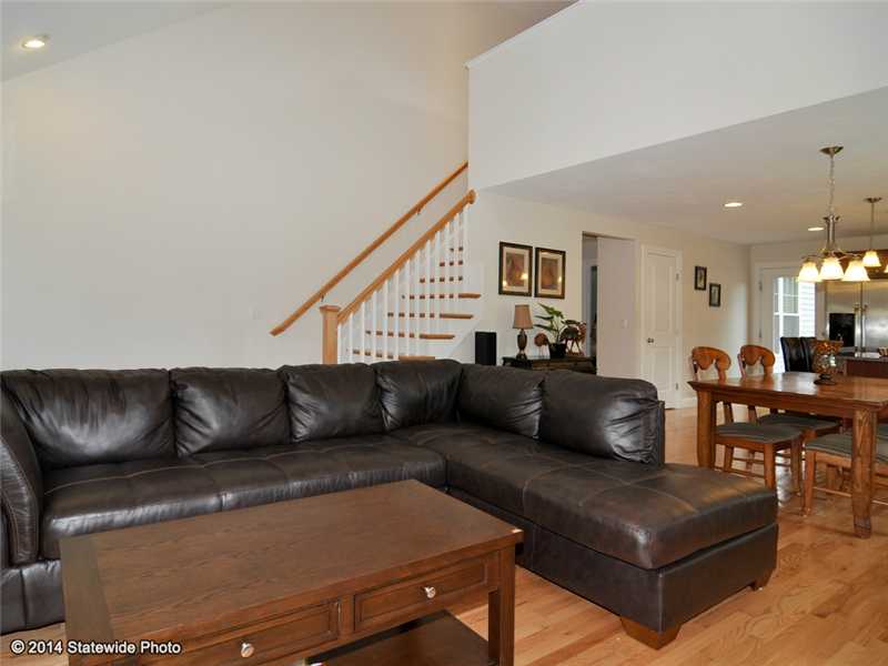 16 Mill Pond Road, Unit 16 Burrillville, RI 02830 - Photo 4 of 25 Living Room. Hardwood stairs lead to loft and guest bed and bath