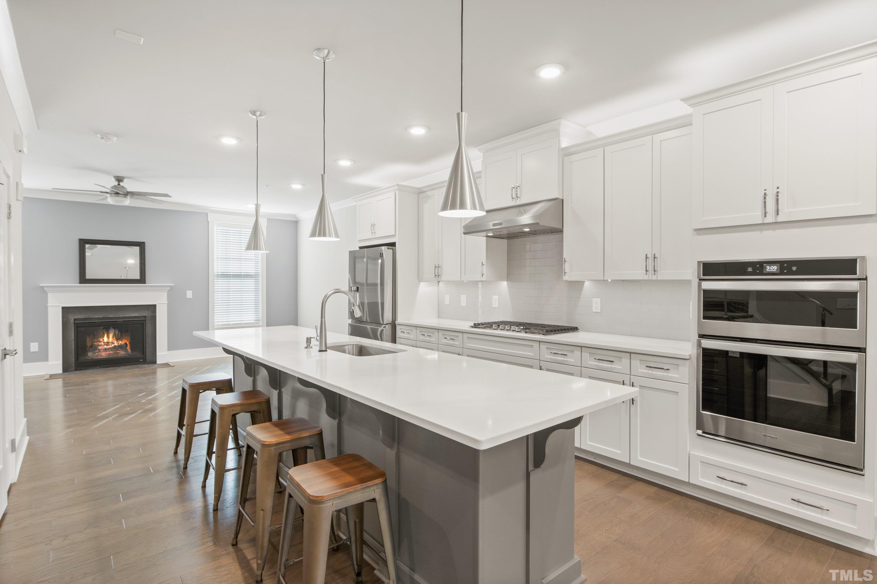 a kitchen with a stove a sink and a refrigerator
