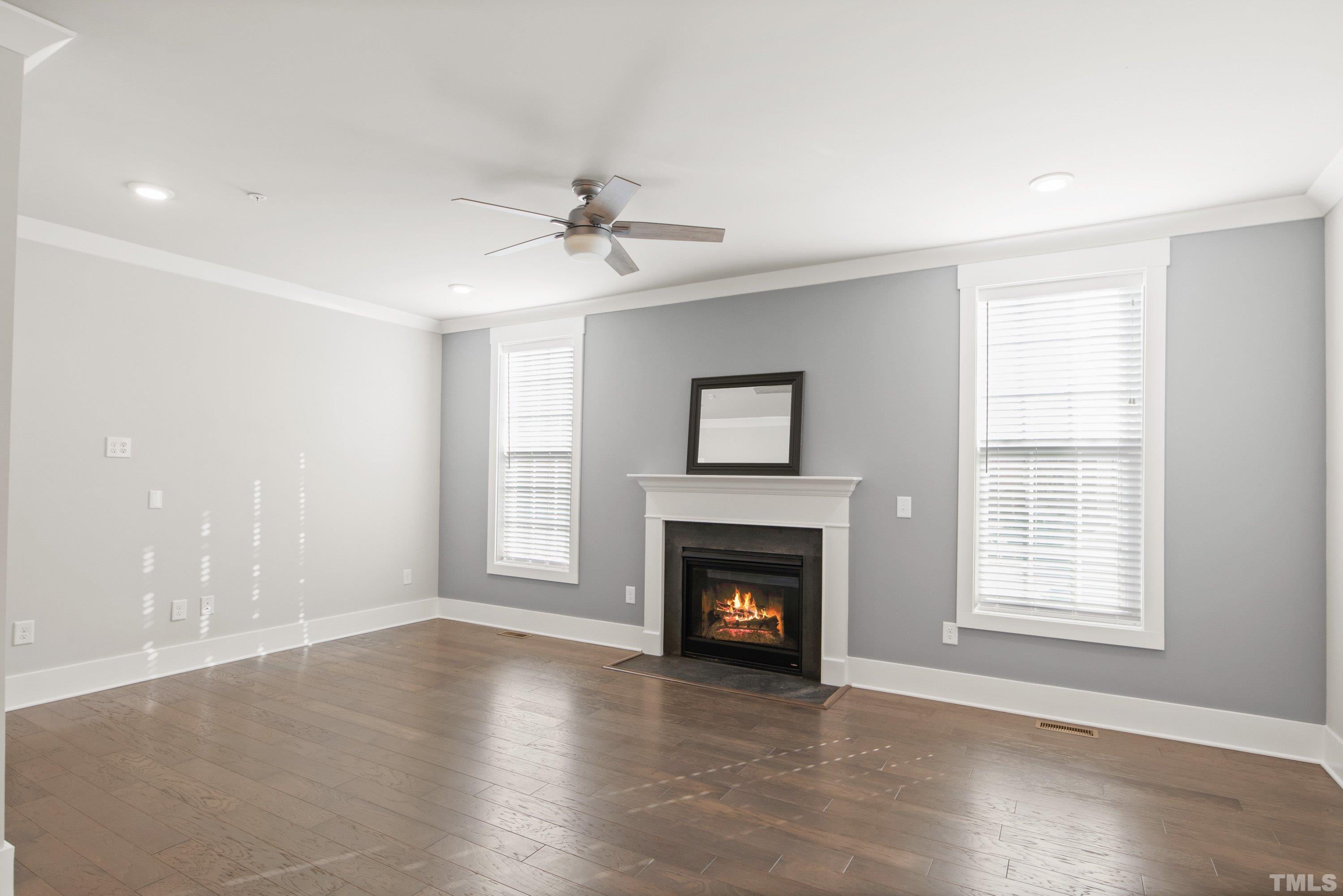 10330 Sablewood Drive, Unit 110 Raleigh, NC 27617 - Photo 14 of 58 a view of empty room with fireplace and wooden floor