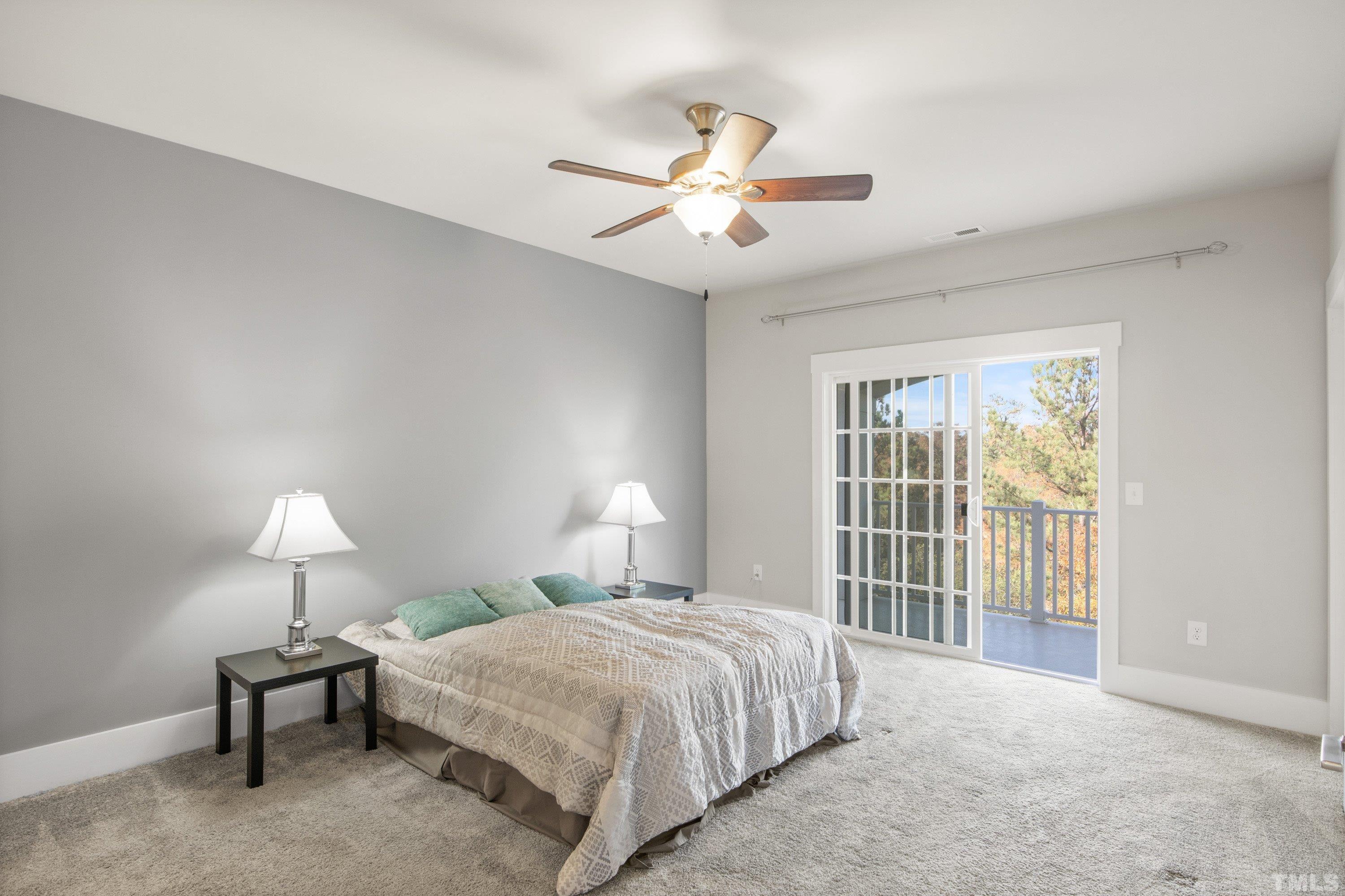 10330 Sablewood Drive, Unit 110 Raleigh, NC 27617 - Photo 29 of 58 a spacious bedroom with a bed and a chandelier