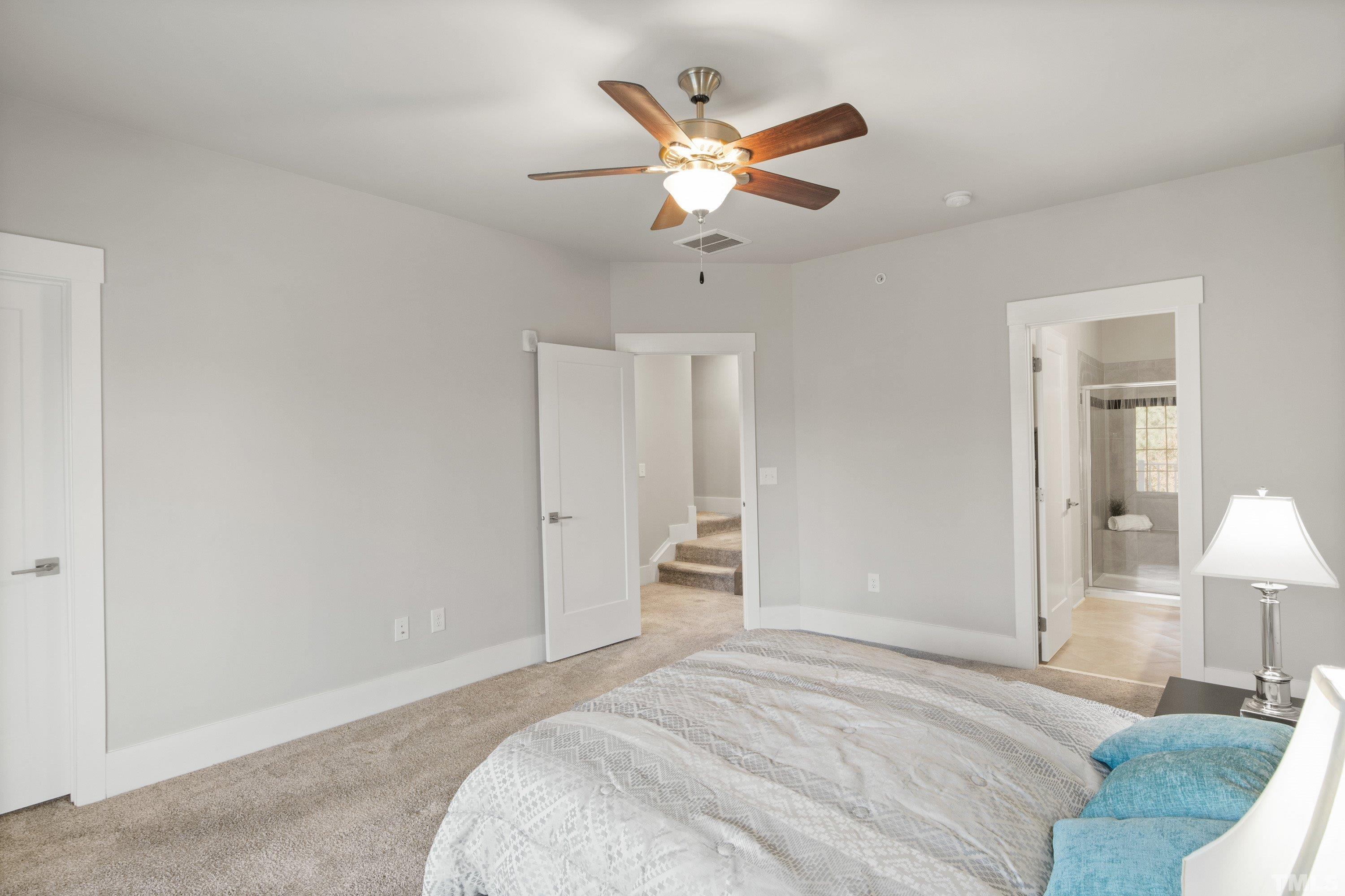 10330 Sablewood Drive, Unit 110 Raleigh, NC 27617 - Photo 31 of 58 a bedroom with a bed and a lamp on the dresser