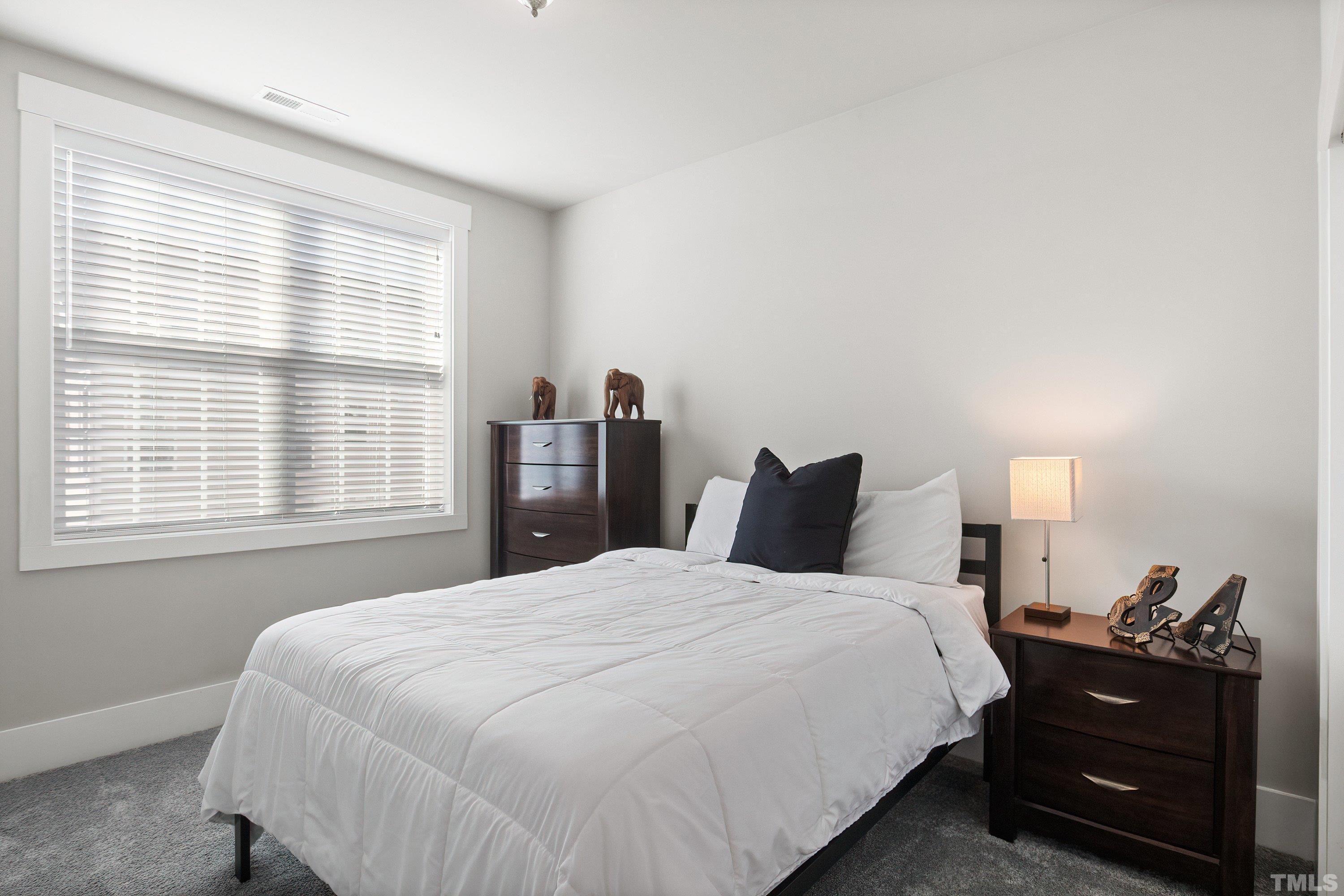 10330 Sablewood Drive, Unit 110 Raleigh, NC 27617 - Photo 35 of 58 a bedroom with a bed and a closet