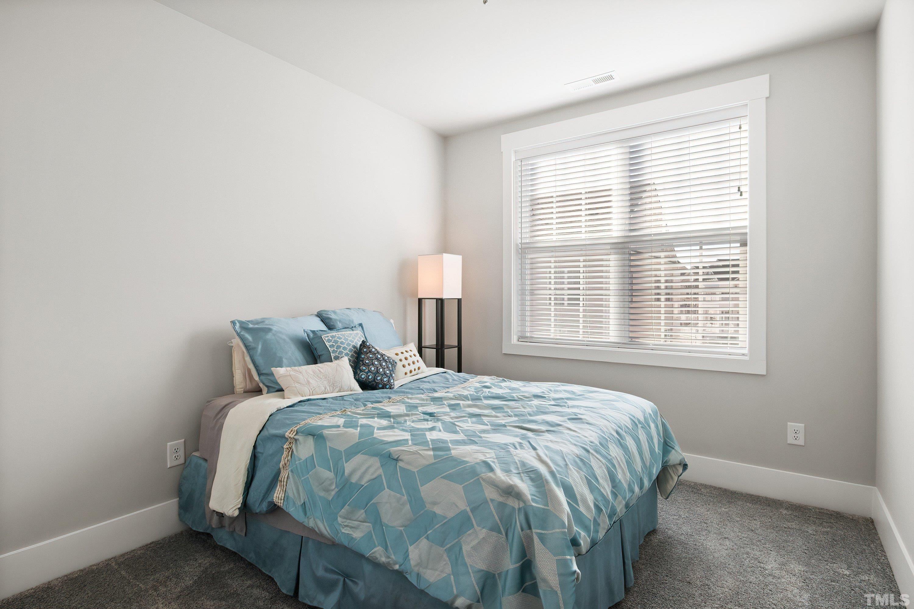 10330 Sablewood Drive, Unit 110 Raleigh, NC 27617 - Photo 38 of 58 a bedroom with a bed and a window