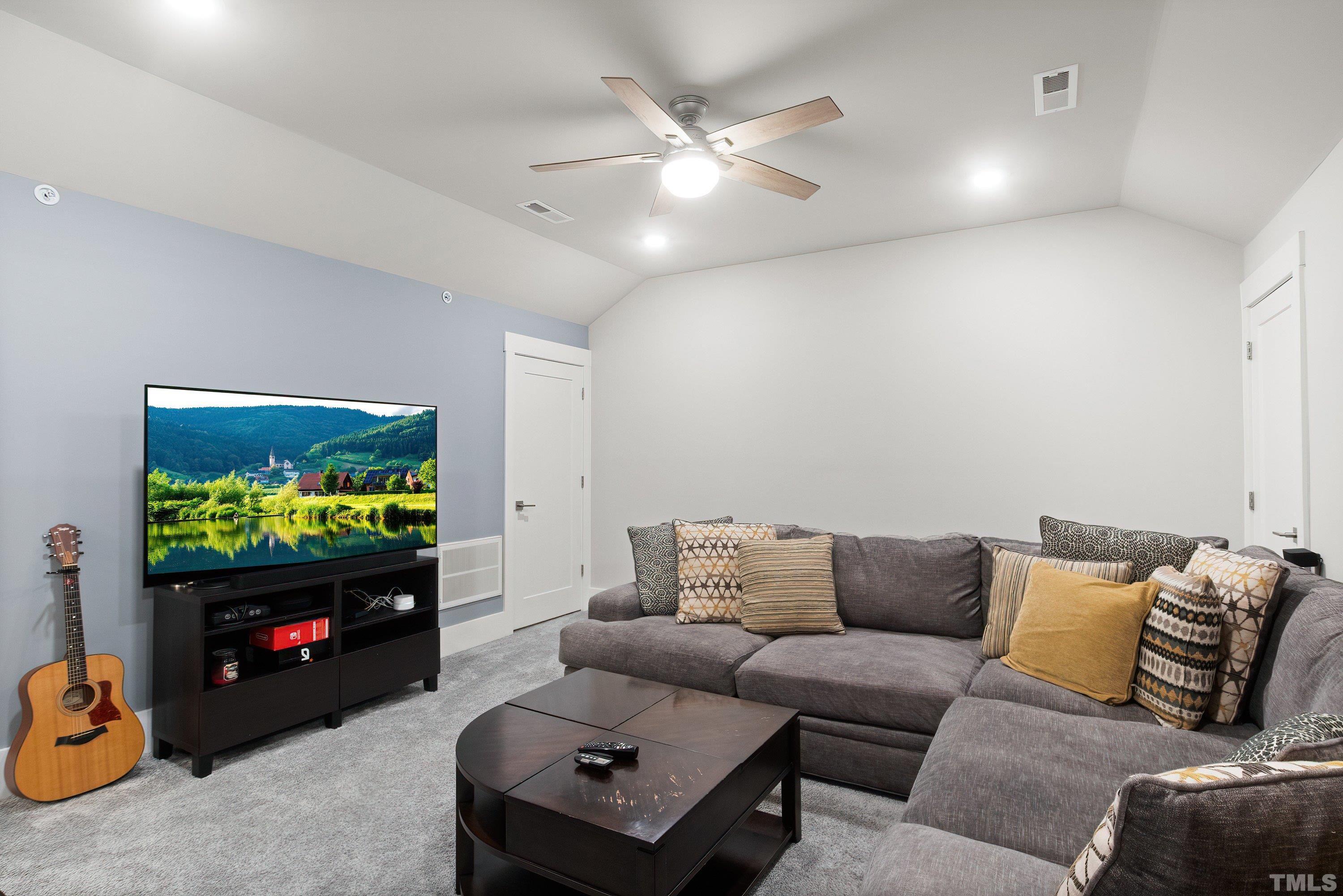 10330 Sablewood Drive, Unit 110 Raleigh, NC 27617 - Photo 42 of 58 a living room with furniture a fireplace and a flat screen tv