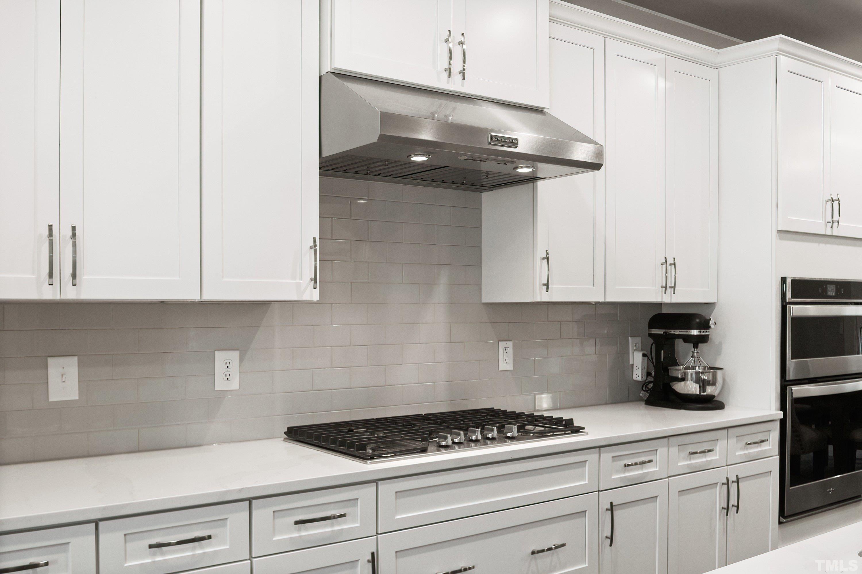 10330 Sablewood Drive, Unit 110 Raleigh, NC 27617 - Photo 8 of 58 a kitchen with white cabinets and appliances