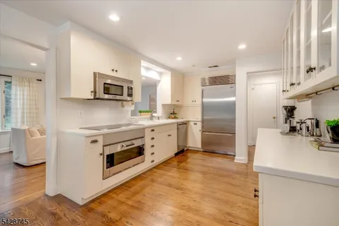 a kitchen with a stove a sink and a refrigerator