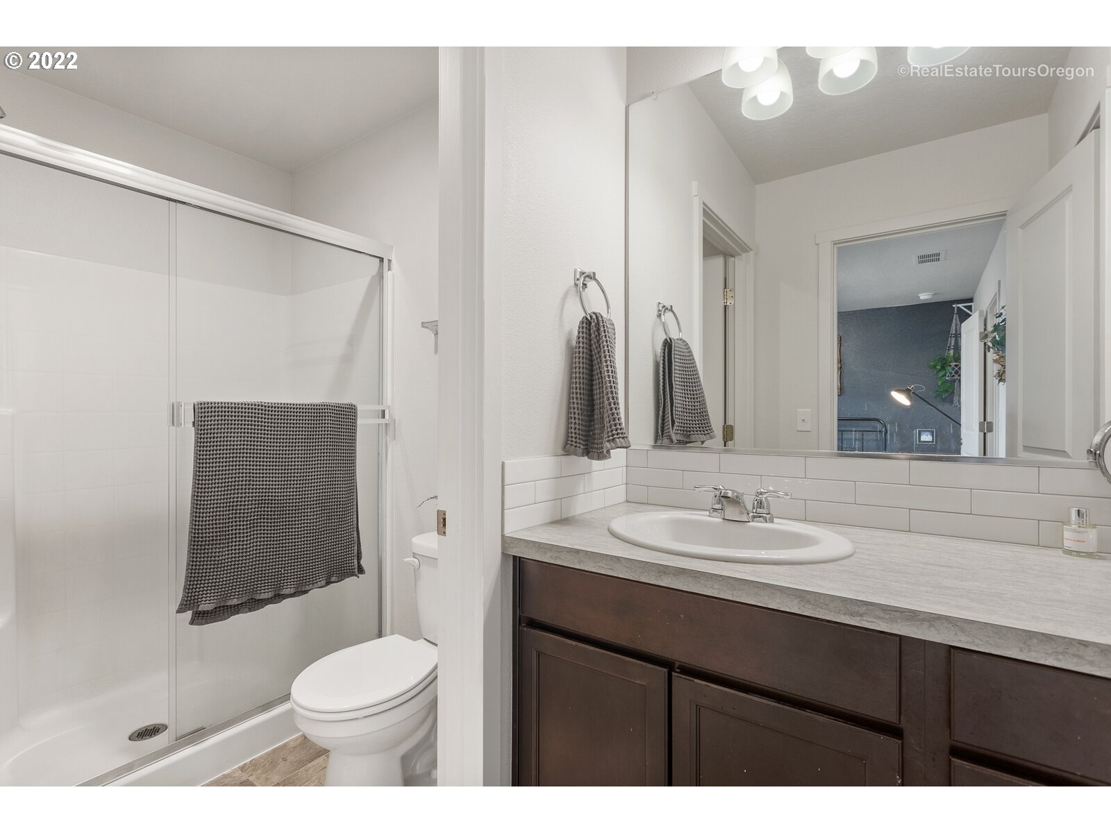 2193 Southeast 16th Street Gresham, OR 97080 - Photo 25 of 32 a bathroom with a sink a toilet a mirror and shower