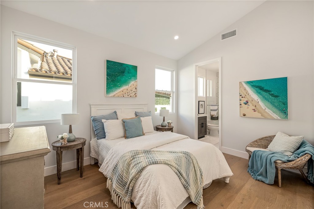 2016 Clark Lane, Unit A Redondo Beach, CA 90278 - Photo 23 of 30 a spacious bedroom with a bed a couch and a window