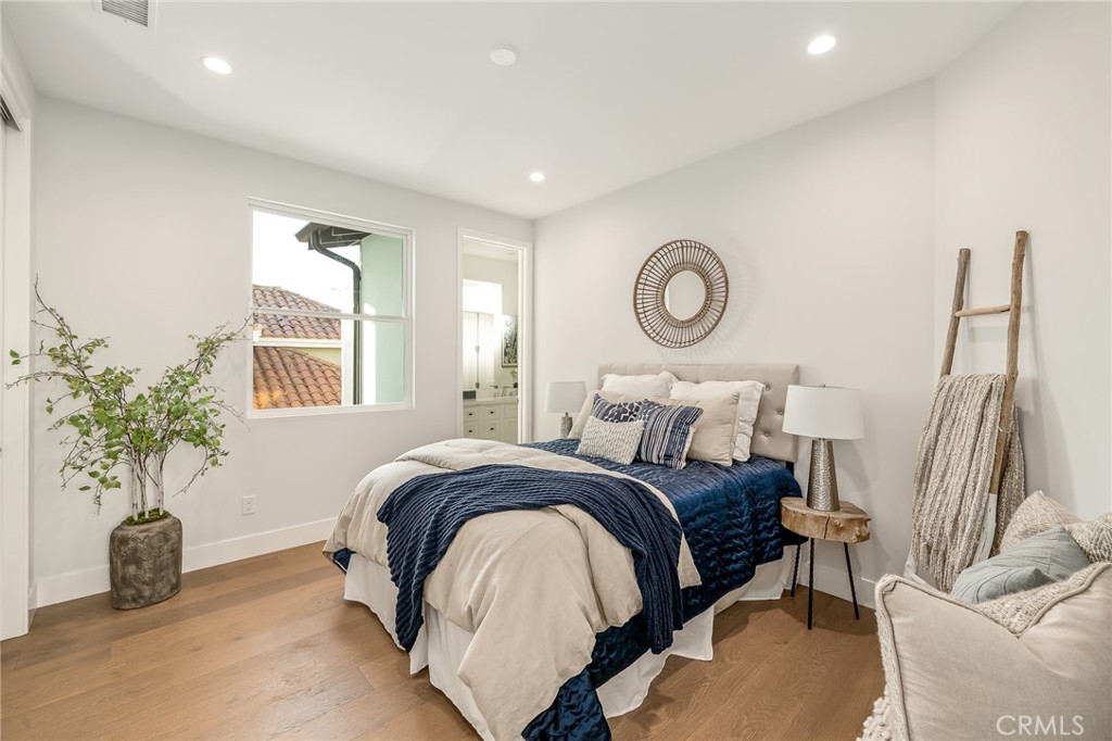 2016 Clark Lane, Unit A Redondo Beach, CA 90278 - Photo 25 of 30 a bedroom with a bed and a potted plant