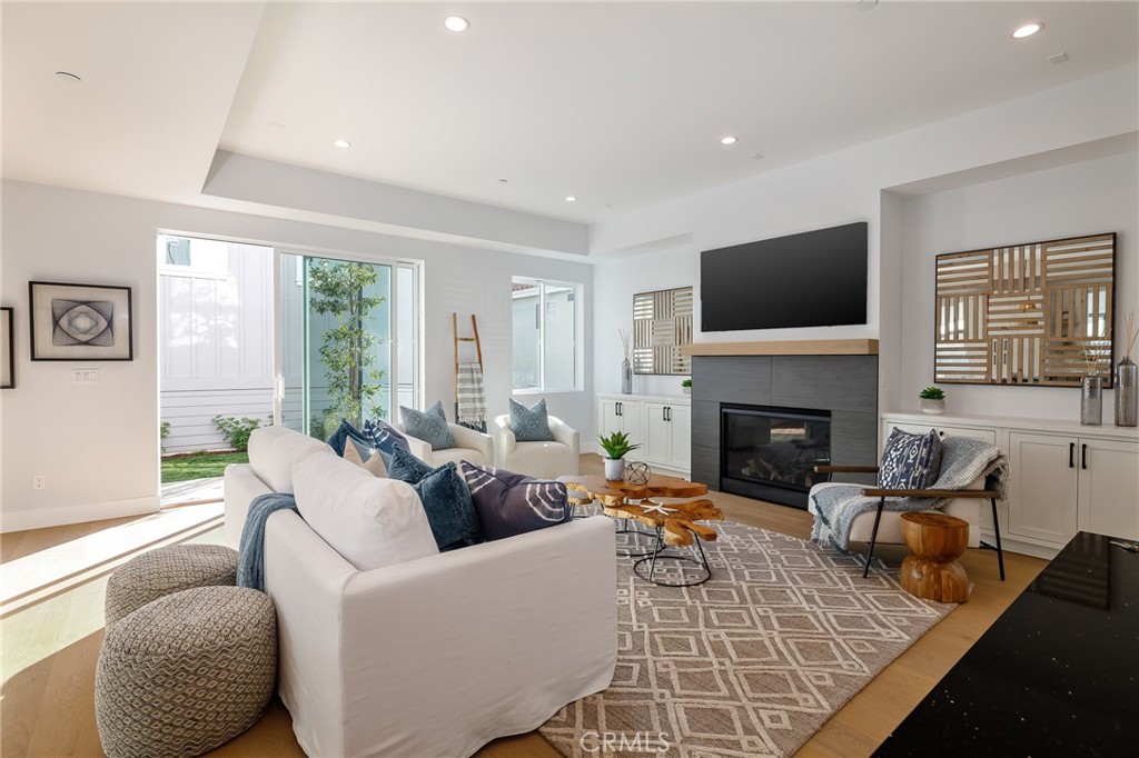 2016 Clark Lane, Unit A Redondo Beach, CA 90278 - Photo 3 of 30 a living room with furniture a fireplace and a flat screen tv