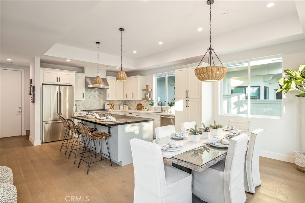 2016 Clark Lane, Unit A Redondo Beach, CA 90278 - Photo 8 of 30 a kitchen with stainless steel appliances kitchen island granite countertop a dining table and chairs