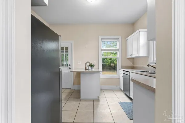 a kitchen with white cabinets and white appliances