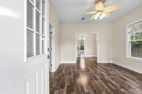 wooden floor in an empty room with a window