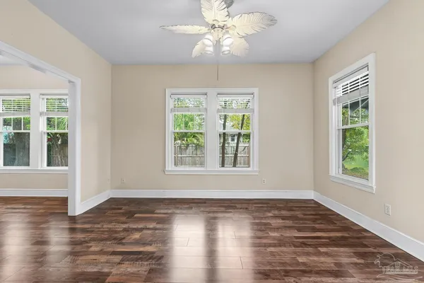 a living room with furniture a flat screen tv and a large window