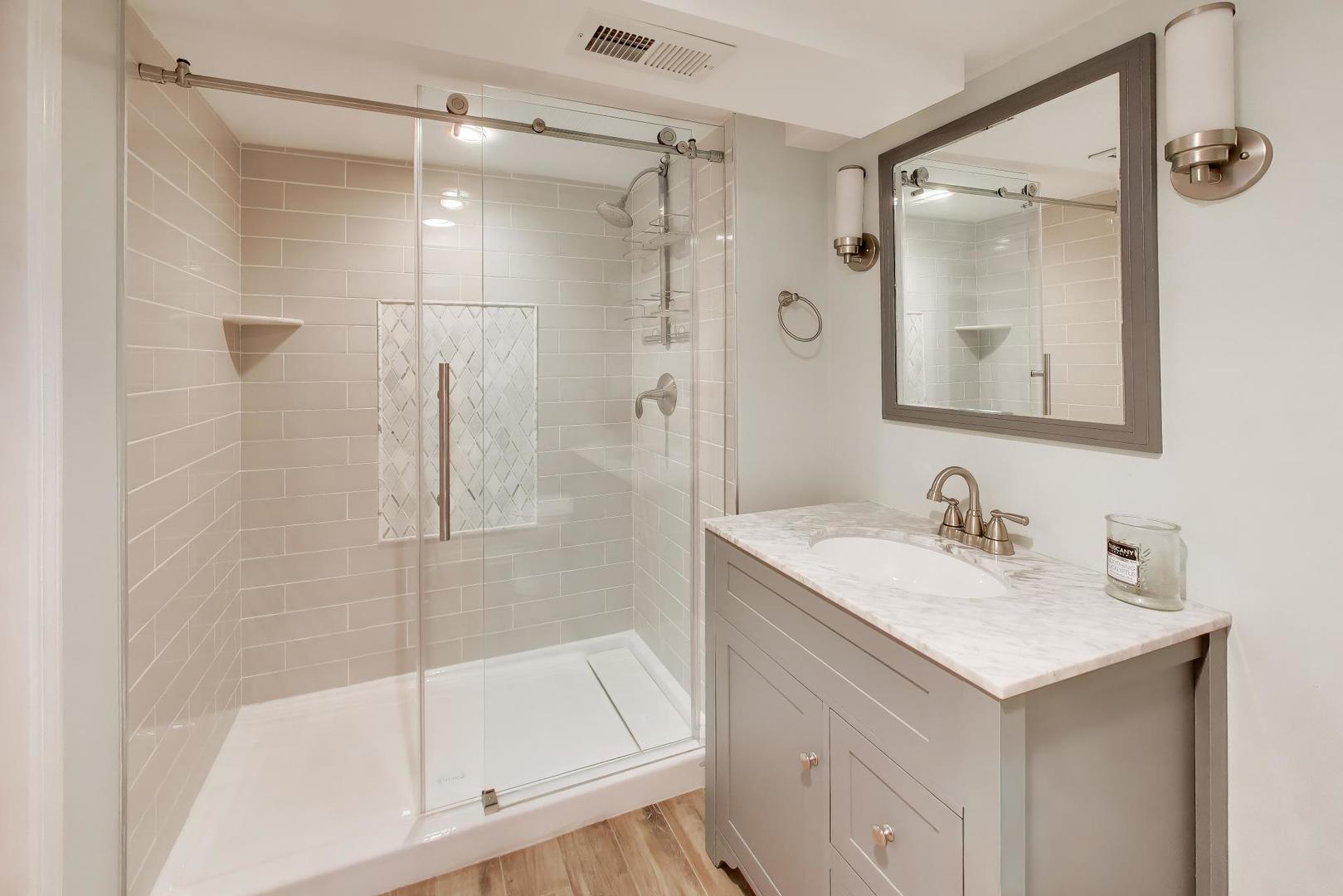 274 Oak Street Elmhurst, IL 60126 - Photo 22 of 31 a bathroom with a shower sink vanity and mirror