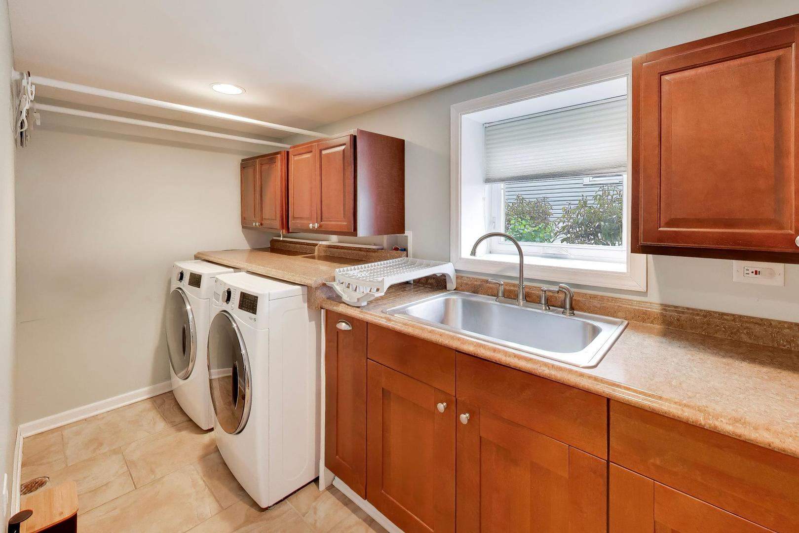 274 Oak Street Elmhurst, IL 60126 - Photo 26 of 31 a utility room with granite countertop a sink a washer and dryer next to a window