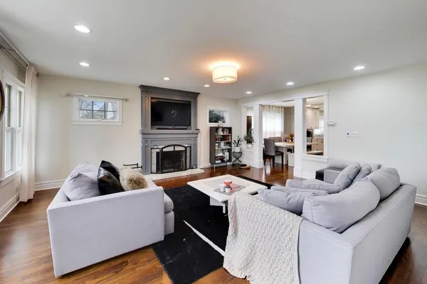 a living room with fireplace furniture and a flat screen tv