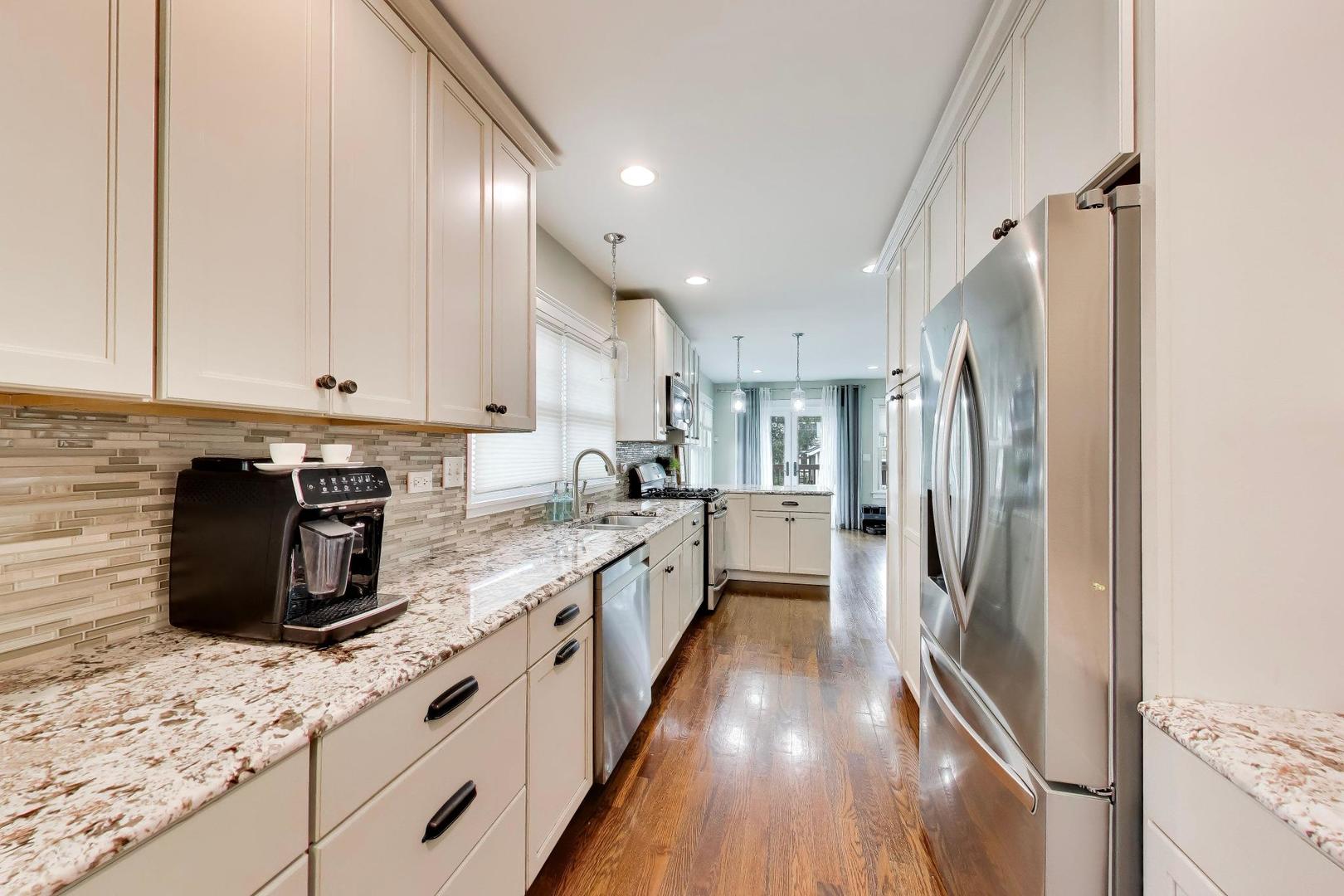 274 Oak Street Elmhurst, IL 60126 - Photo 7 of 31 a large kitchen with stainless steel appliances granite countertop a refrigerator a stove a sink and a microwave