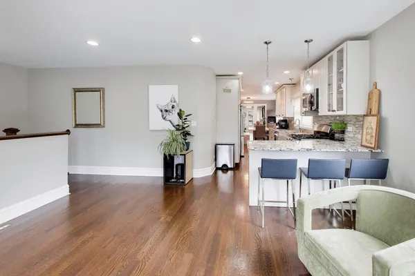 a living room with kitchen island furniture and a wooden floor