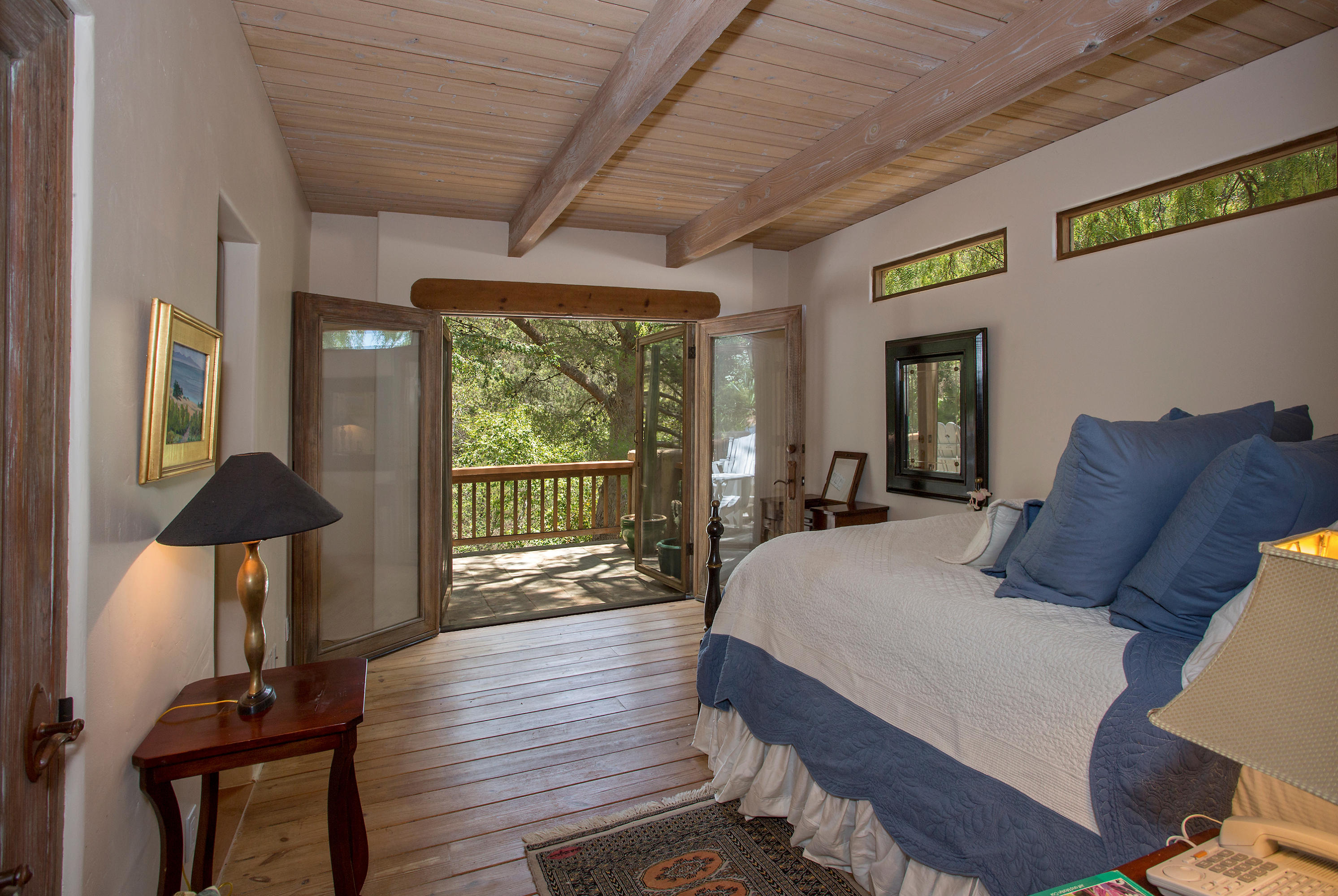 1090 Toro Canyon Road Santa Barbara, CA 93108 - Photo 11 of 28 a bed room with a bed and a lamp