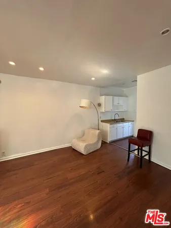 a room with wooden floor and furniture