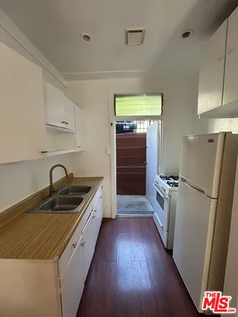 a kitchen with a refrigerator and a sink