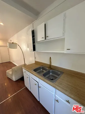 a kitchen with a sink and cabinets