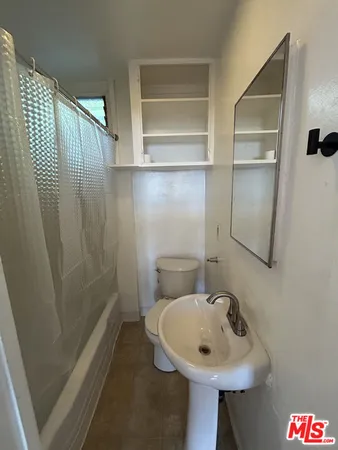 a bathroom with a sink a toilet and a shower