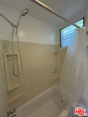 a bathroom with a shower and a bathtub