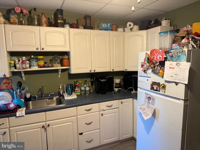 a white refrigerator freezer sitting inside of a kitchen